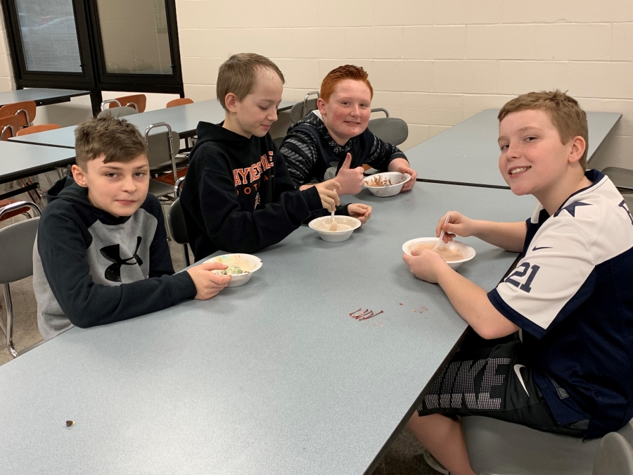 students at tables with bowls of ice cream